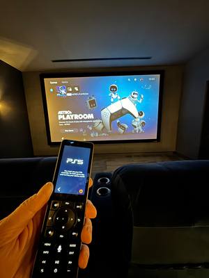 Home cinema room with universal remote control and PS5 gaming setup